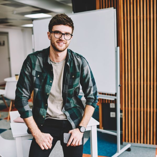 White_Man_Sitting_On_Desk_AdobeStock_370759882_Smaller